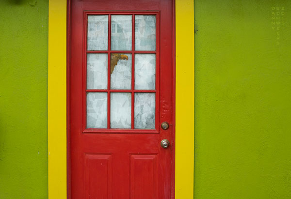 Red door, yellow trim, and green walls on storefront in Madrid, New Mexico, 2015 by Danny N. Schweers