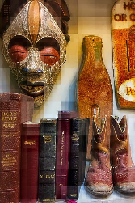 Bible, tribal mask, rusty signs in antique store