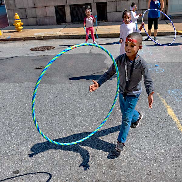 boy spinning plastic hoop in the air - photo by Danny N. Schweers