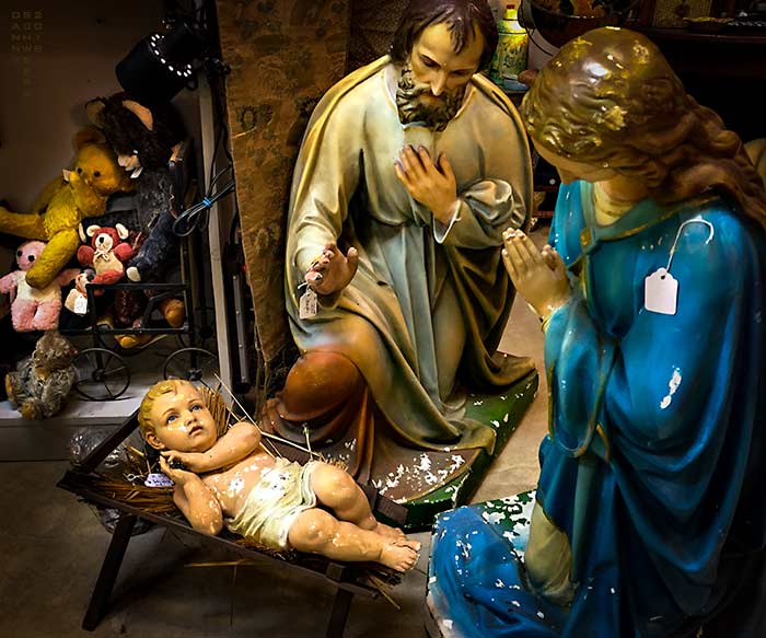 Photo of plaster statues of Jesus, Joseph, and Mary for sale in an antique store.