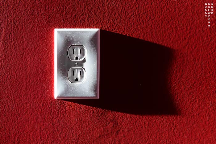Photo of an electrical outlet in slanting sunlight