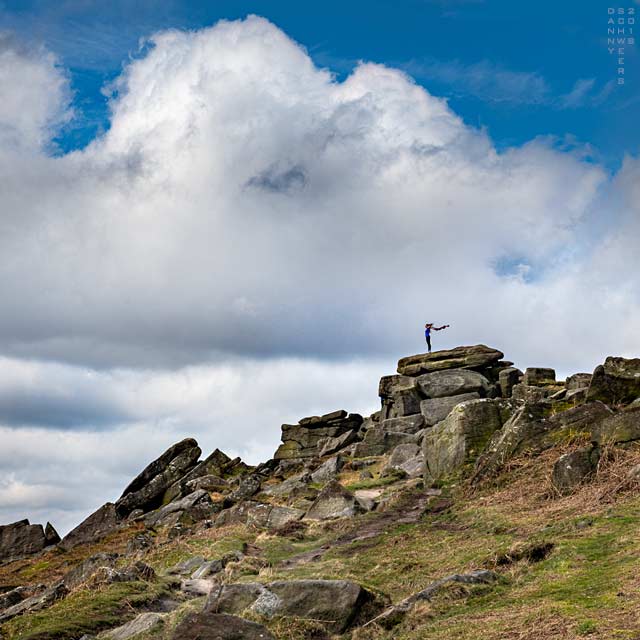 Woman atop Stanage Edge, Peak District National Park, England by Danny N. Schweers
